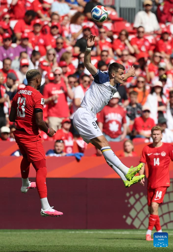 Derek Cornelius (L) of Canada vies with Samed Bazdar (C) of Bosnia and Herzegovina during the group B match between Canada and Bosnia and Herzegovina at the 2026 FIFA World Cup at Toronto Stadium in Toronto, Canada, June 12, 2026. (Photo by Zou Zheng/Xinhua)