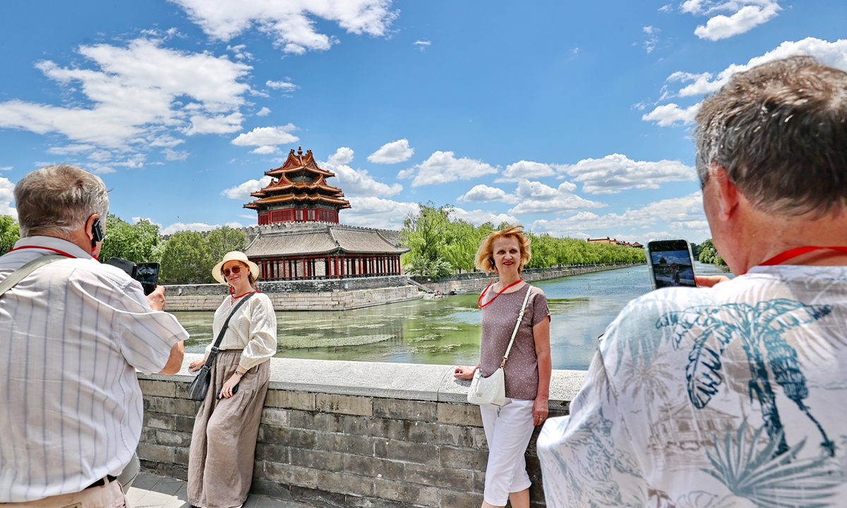 Foreign tourists take photos of the Corner Tower of the Palace Museum under Beijing's blue sky and white clouds on June 9, 2026. Beijing has made notable environmental strides in recent years, achieving breakthroughs in air quality, water ecology and urban greening. Photo: IC