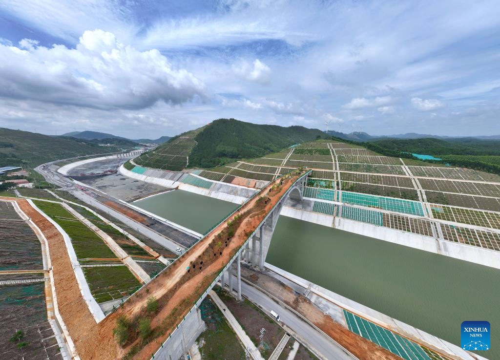 A drone photo taken on June 8, 2026 shows a view of the dedicated wildlife corridor bridge of the Pinglu Canal in Jiuzhou Town, Lingshan County of Qinzhou City in south China's Guangxi Zhuang Autonomous Region. As the country's first one of its kind to cross a large-scale canal, this 240-meter ecological corridor facilitates the migration of animals including masked palm civets, leopard cats, and red-bellied squirrels along both its banks. With simulation design, the structure induces wildlife to cross it as they do with a natural passage. (Photo: Xinhua)