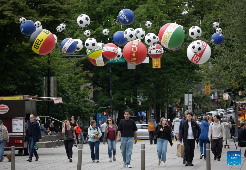 Soccer-themed decorations are seen above pedestrians in downtown Vancouver, British Columbia, Canada, June 9, 2026. Vancouver is making final preparations to welcome fans from around the world for the 2026 FIFA World Cup. (Photo: Xinhua)