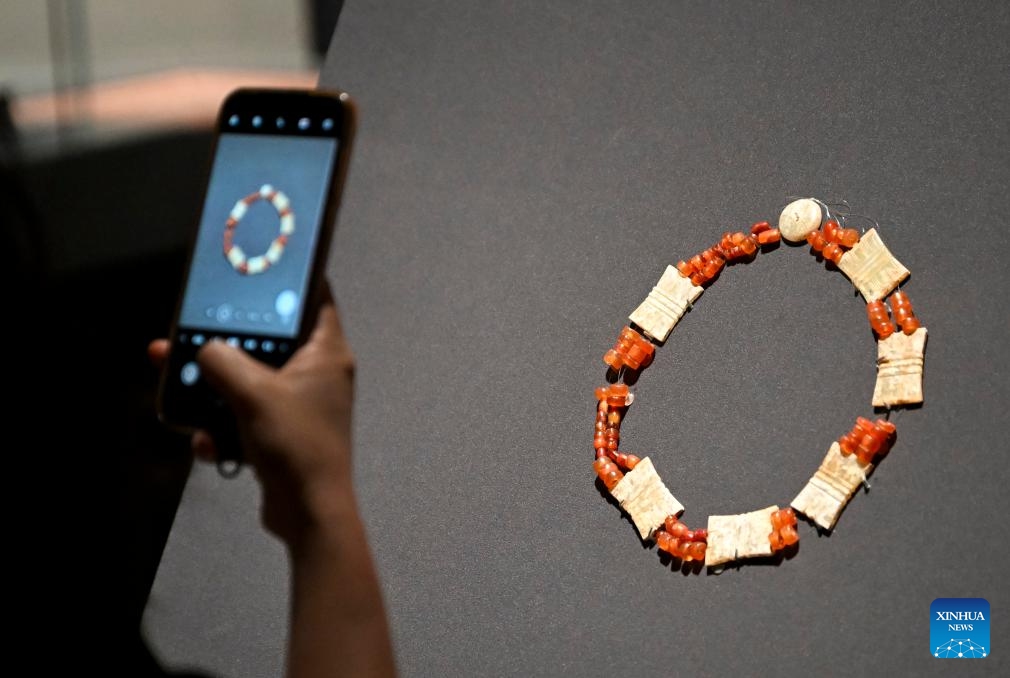 A media staff member takes photos of an exhibit during a press preview of the exhibition Dawn of The First Empire: The Qin's Unification in Archaeological Treasures at the Shanghai Museum in Shanghai, east China, June 9, 2026. The exhibition will be open to the public from June 10 to Sept. 7, displaying 328 sets (510 pieces) of cultural relics from 14 archaeological and cultural heritage institutions from northwest China's Gansu and Shaanxi provinces and Shanghai. (Photo: Xinhua)