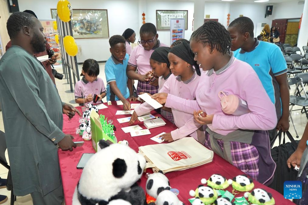 Students choose panda-themed cultural creative products during the opening event of the Hello Nigeria 2026 Panda Painting Interactive Experience Exhibition at the China Cultural Center in Abuja, Nigeria, on June 8, 2026. More than 200 students and teachers from six local international schools participated in the opening event on Monday. (Photo: Xinhua)