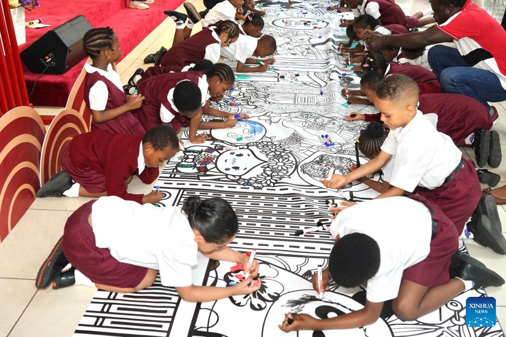 Students paint on a scroll during the opening event of the Hello Nigeria 2026 Panda Painting Interactive Experience Exhibition at the China Cultural Center in Abuja, Nigeria, on June 8, 2026. More than 200 students and teachers from six local international schools participated in the opening event on Monday. (Photo: Xinhua)