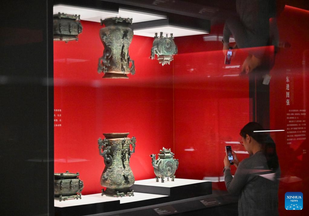 A media staff member takes photos of an exhibit during a press preview of the exhibition Dawn of The First Empire: The Qin's Unification in Archaeological Treasures at the Shanghai Museum in Shanghai, east China, June 9, 2026. The exhibition will be open to the public from June 10 to Sept. 7, displaying 328 sets (510 pieces) of cultural relics from 14 archaeological and cultural heritage institutions from northwest China's Gansu and Shaanxi provinces and Shanghai. (Photo: Xinhua)