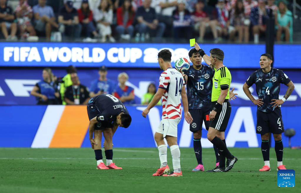 Head referee gives yellow card to Diego Gomez (1st L) of Paraguay during the group D match between the United States and Paraguay at the 2026 FIFA World Cup at Los Angeles Stadium in Los Angeles, the United States, June 12, 2026. (Xinhua/Mao Siqian)