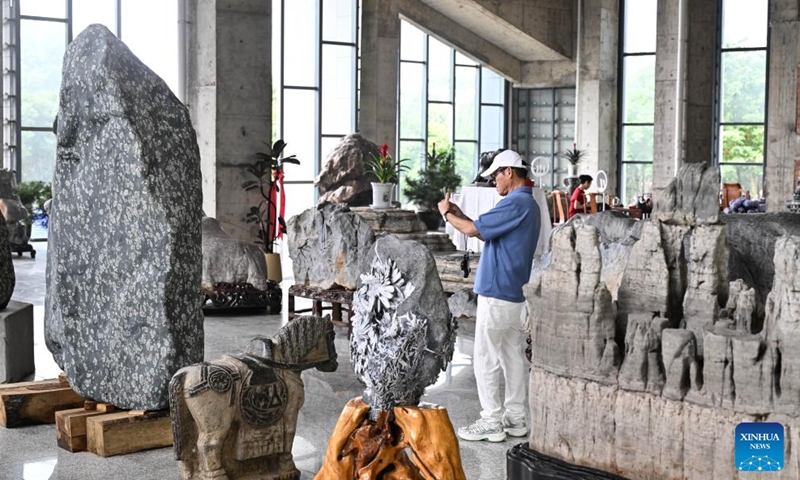 A visitor is seen at an ornamental stone museum in Xuyi, east China's Jiangsu Province, June 8, 2026. The museum opened here on Monday, displaying over 230,000 ornamental stones in a 100-hectare complex. (Photo: Xinhua)