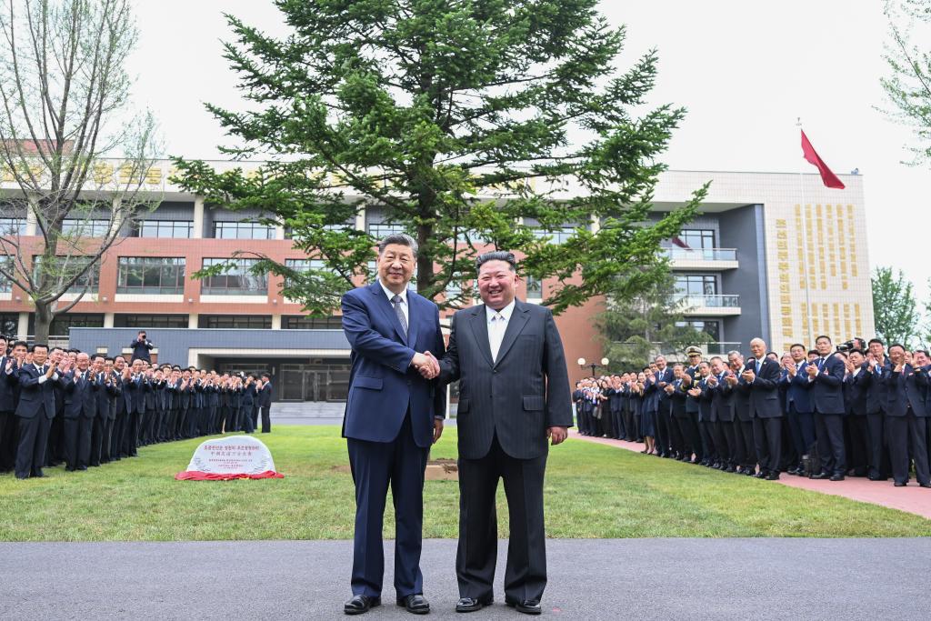 Xi Jinping, general secretary of the Communist Party of China Central Committee and Chinese president, shakes hands with Kim Jong Un, general secretary of the Workers' Party of Korea (WPK) and president of the State Affairs of the Democratic People's Republic of Korea (DPRK), after they have jointly planted a fir tree in the wooded area between teaching buildings of the Central Cadres Training School of the WPK in Pyongyang, the DPRK, June 9, 2026. On Tuesday morning, Xi, accompanied by Kim, visited the Central Cadres Training School of the WPK in Pyongyang. (Photo: Xinhua)