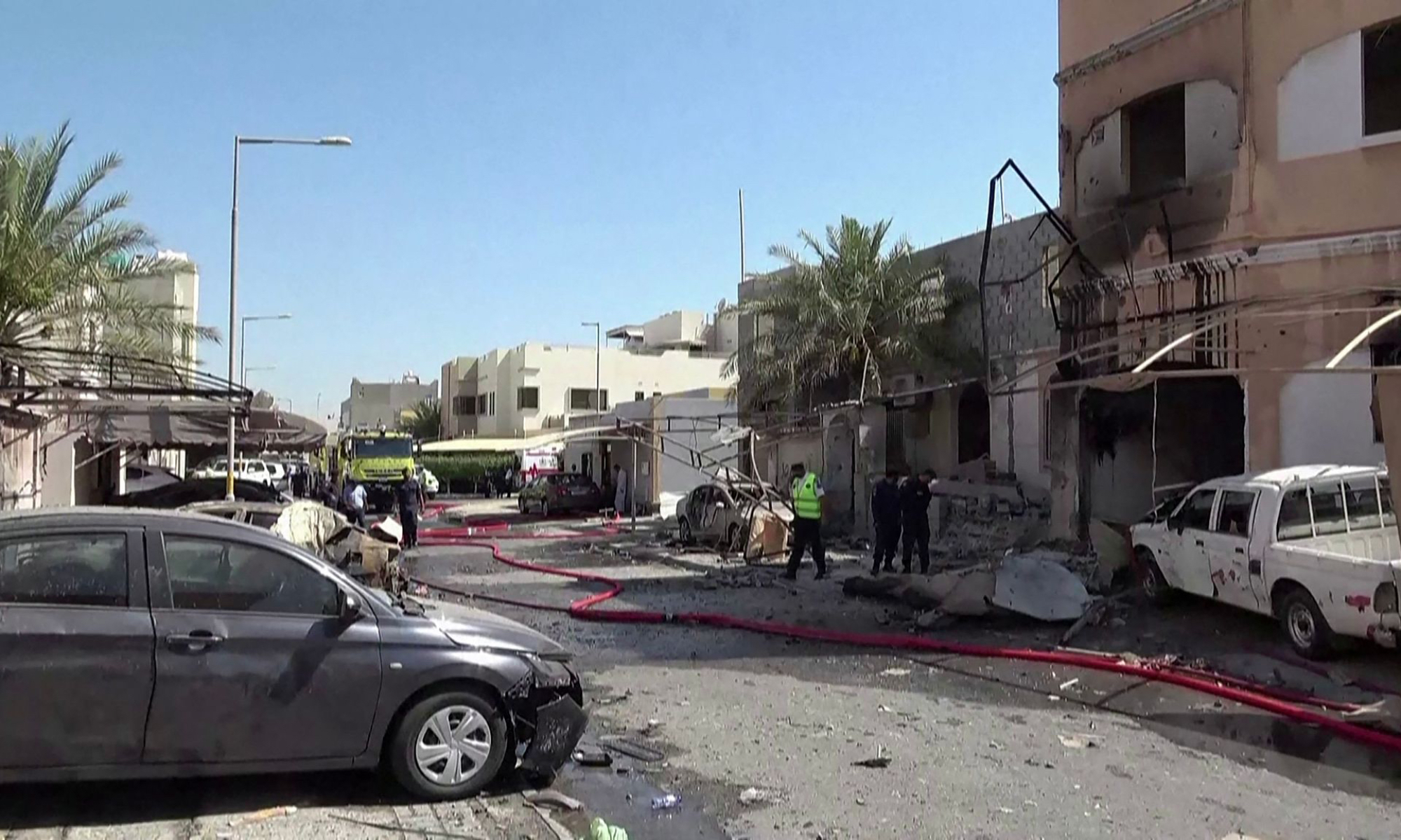 This screen grab taken from handout footage released by Bahrain TV on June 11, 2026, shows damage to buildings and vehicles in Bahrain reportedly caused by debris from intercepted drones. Photo: VCG