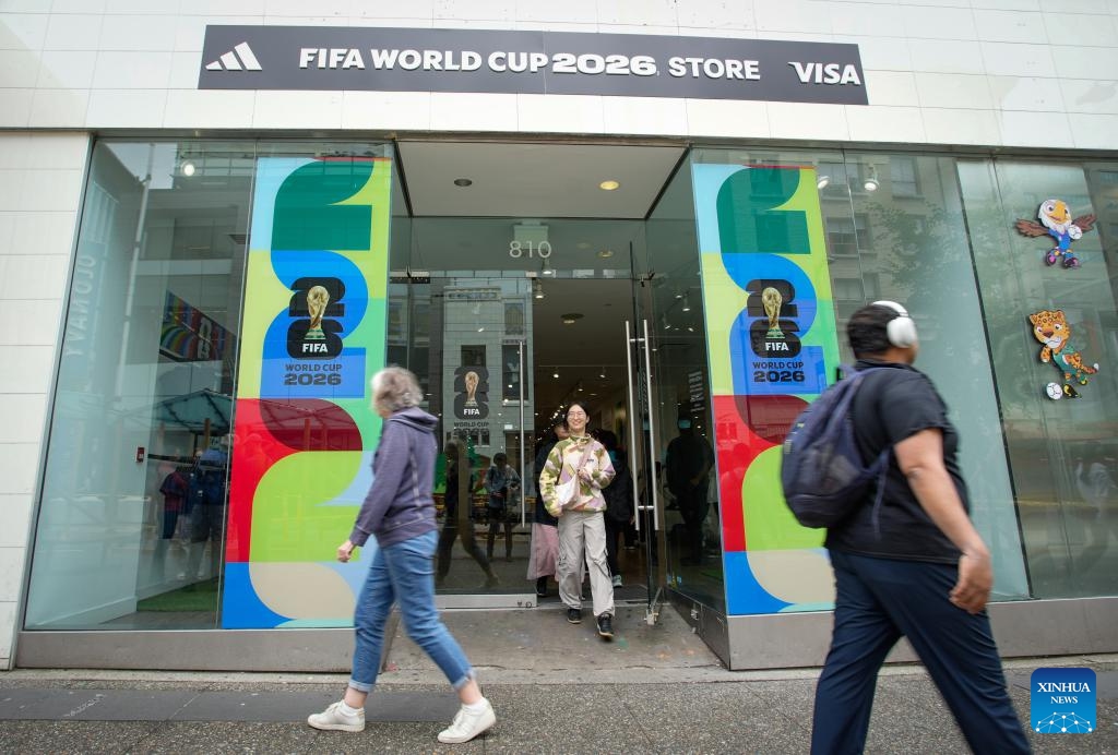 People walk past a newly opened official 2026 FIFA World Cup merchandise store in downtown Vancouver, British Columbia, Canada, June 9, 2026. Vancouver is making final preparations to welcome fans from around the world for the 2026 FIFA World Cup. (Photo: Xinhua)