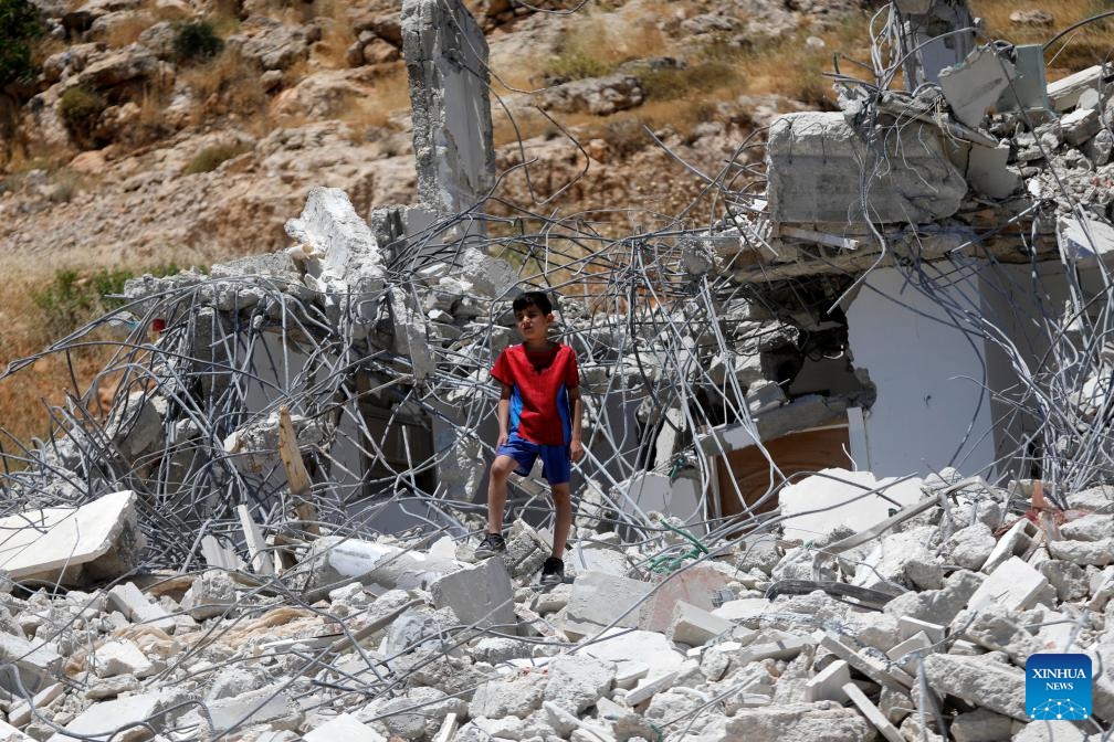A Palestinian inspects the rubble after Israeli excavators demolished a Palestinian home and a carpentry workshop in the Khirbet Qalqas area, south of Hebron, in the West Bank, on June 8, 2026. (Photo: Xinhua)