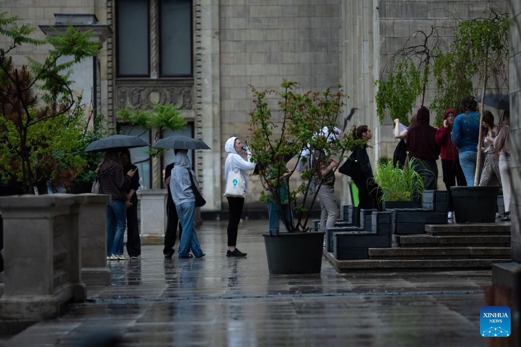People line up to enter a theater in Warsaw, Poland, June 9, 2026. Warsaw experienced a sharp weather change on Tuesday as temperature rose high in the afternoon before rain and cold air caused a rapid temperature drop. (Photo: Xinhua)