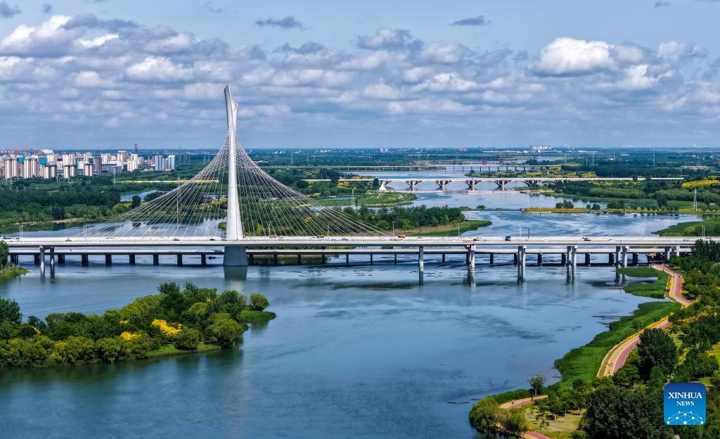 An aerial drone photo taken on June 6, 2026 shows a view along the Hutuo River in Shijiazhuang, north China's Hebei Province. The Shijiazhuang section of the Hutuo River is about 205 kilometers long and flows through many districts and counties of the city. It is called the mother river of the city. Since 2017, Shijiazhuang has implemented ecological restoration in stages along the river. Nowadays, the banks of the Hutuo River have become popular leisure destinations for local residents, while a growing number of emerging urban functions are also clustered here. (Photo: Xinhua)