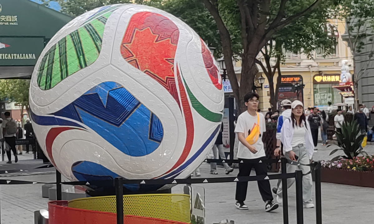 Pedestrians walk past a giant football nearly three meters in height on the Central Street in Harbin, Northeast China's Heilongjiang Province, on June 11, 2026. Photo: VCG