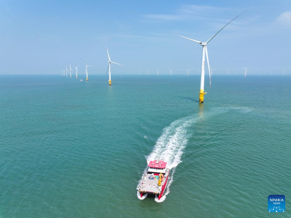 An aerial drone photo taken on June 10, 2026 shows a maintenance vessel sailing at an offshore wind farm in Rudong, east China's Jiangsu Province. (Photo: Xinhua)