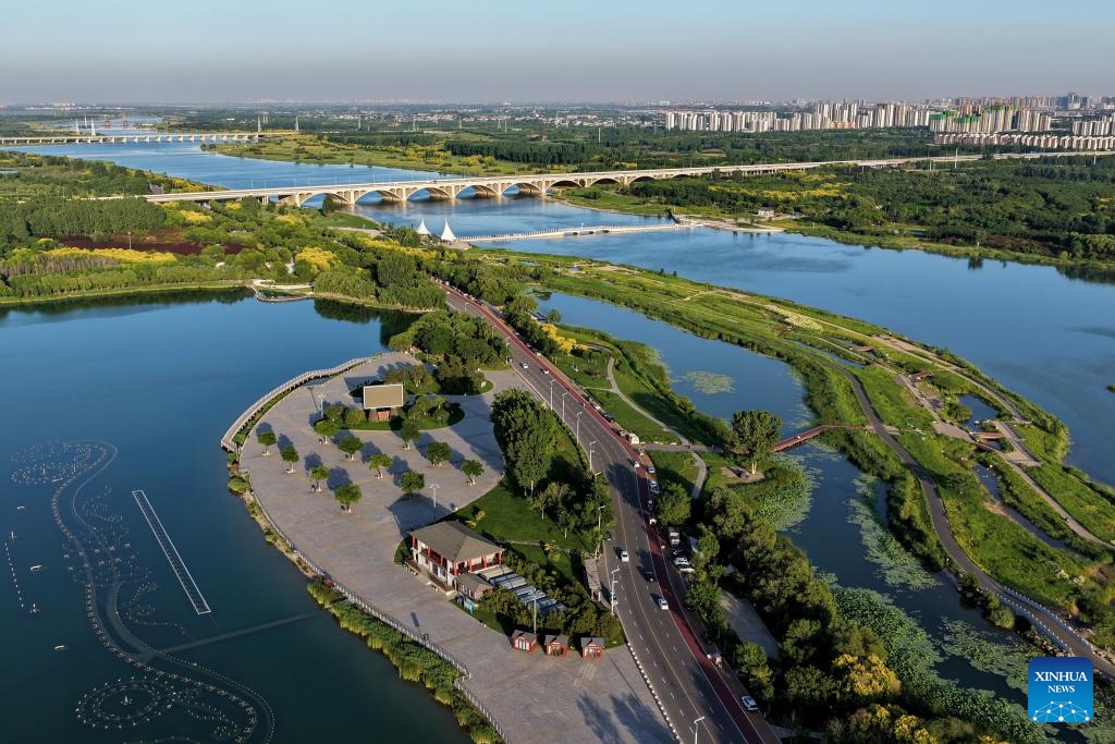 An aerial drone photo taken on June 1, 2026 shows a view along the Hutuo River in Shijiazhuang, north China's Hebei Province. The Shijiazhuang section of the Hutuo River is about 205 kilometers long and flows through many districts and counties of the city. It is called the mother river of the city. Since 2017, Shijiazhuang has implemented ecological restoration in stages along the river. Nowadays, the banks of the Hutuo River have become popular leisure destinations for local residents, while a growing number of emerging urban functions are also clustered here. (Photo: Xinhua)
