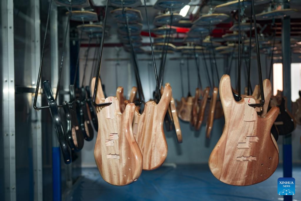 This photo taken on June 9, 2026 shows the automatic guitar painting production line in Zunyi Shenqu Musical Instrument Manufacturing Co., Ltd. in Zheng'an County, Zunyi City, southwest China's Guizhou Province. (Photo: Xinhua)