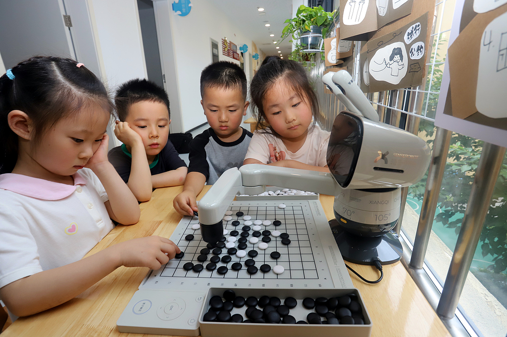 Children play chess with intelligent robots at Guanyun Experimental Kindergarten in Gusu district, Suzhou, East China's Jiangsu Province, on June 16, 2026. A smart sensor tracks every move, creating a fun brain game combining tradition and technology. Photo: VCG