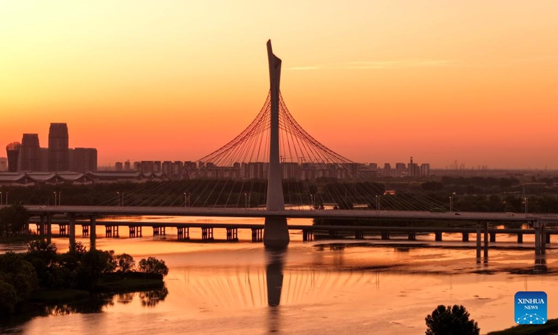 A drone photo taken on May 29, 2026 shows a bridge crossing the Hutuo River in Shijiazhuang, north China's Hebei Province. The Shijiazhuang section of the Hutuo River is about 205 kilometers long and flows through many districts and counties of the city. It is called the mother river of the city. Since 2017, Shijiazhuang has implemented ecological restoration in stages along the river. Nowadays, the banks of the Hutuo River have become popular leisure destinations for local residents, while a growing number of emerging urban functions are also clustered here. (Photo: Xinhua)