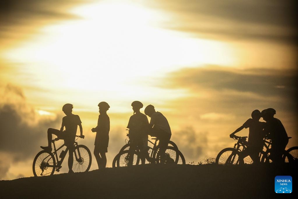 Cyclists enjoy the view of sunset in Ilocos Sur Province, the Philippines, on June 11, 2026. (Xinhua/Rouelle Umali)