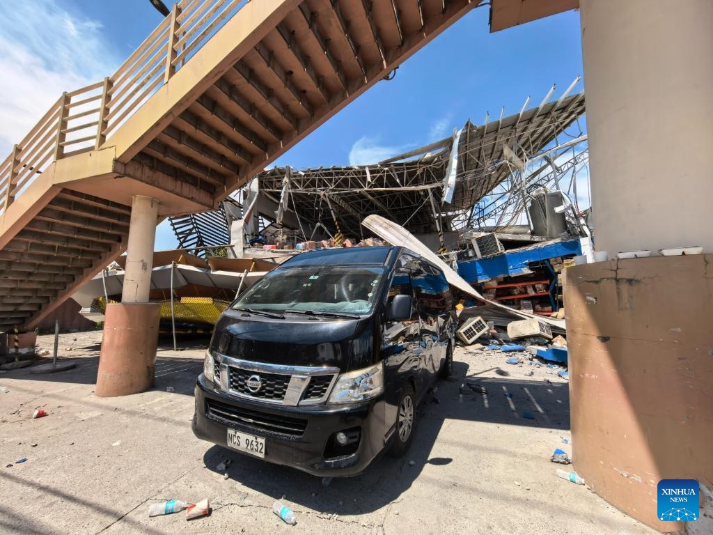 This photo taken on June 10, 2026 shows buildings and a vehicle damaged during an earthquake, in General Santos City, the Philippines. At least 47 people were killed, 31 missing and 688 injured after a magnitude 7.8 earthquake struck off the southern coast of Mindanao, the Philippines, on Monday, said the National Disaster Risk Reduction and Management Council (NDRRMC) on Thursday. (Str/Xinhua)