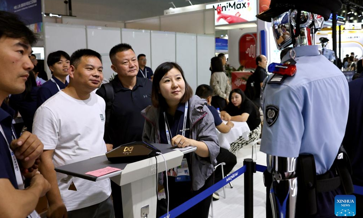 Visitors view a community security robot during the 12th China (Shanghai) International Technology Fair (CSITF) in east China's Shanghai, June 11, 2026. The 12th China (Shanghai) International Technology Fair, scheduled from June 11 to 13, kicked off at the Shanghai World Expo Exhibition and Convention Center on Thursday. The fair covers an exhibition area of about 38,000 square meters, showcasing innovative technological achievements in fields including artificial intelligence, green fuels, energy storage and transportation, smart home application and elderly care. (Xinhua/Fang Zhe)