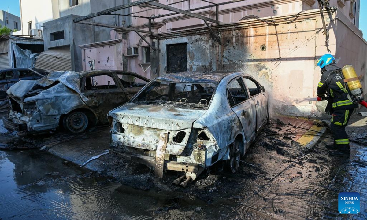 A member of Bahrain's Civil Defense extinguishes a fire caused by falling debris from intercepted Iranian drones in Hamad Town, Bahrain, on June 11, 2026. An 11-year-old girl sustained minor injuries after debris from intercepted Iranian drones fell in Bahrain, damaging some houses, Bahrain's Interior Ministry said Thursday. Iran's Islamic Revolution Guard Corps said Thursday it had launched attacks on U.S. military bases in Jordan, Kuwait and Bahrain in retaliation for U.S. strikes. (Bahrain's Interior Ministry/Handout via Xinhua)