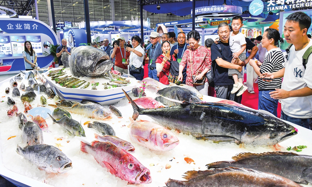 Visitors observe various marine fish on display at the China International Seafood & Fisheries Expo held in Fuzhou, East China's Fujian Province, on June 12, 2026. The expo features 10 themed exhibition zones, including
