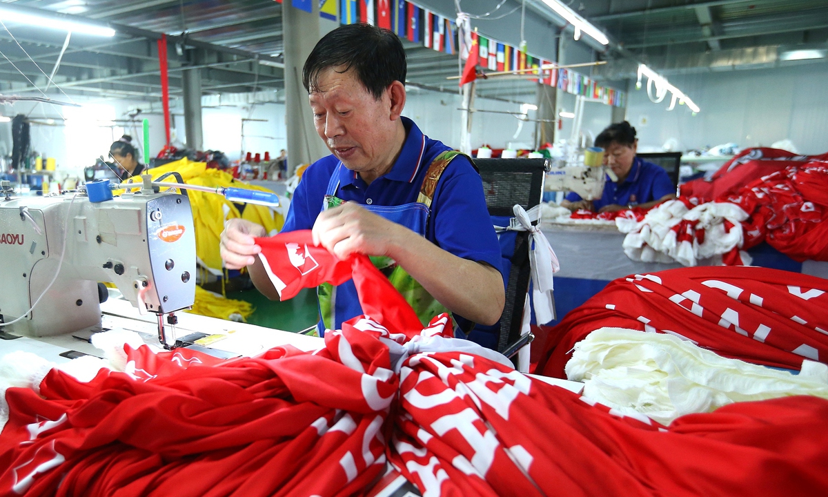 Workers at a textile company in Qingdao, East China's Shandong Province, produce flags for the 2026 FIFA World Cup on May 28, 2026. Photo: VCG