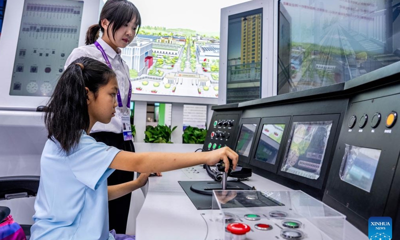 A young visitor tries a subway simulator at the 10th China-South Asia Expo in Kunming, southwest China's Yunnan Province, June 12, 2026. The 10th China-South Asia Expo kicked off on Thursday in Kunming City, capital of southwest China's Yunnan Province. The event has put an emphasis on enhancing regional trade and industrial cooperation under the theme Solidarity and Coordination for Common Development. (Xinhua/Hu Chao)