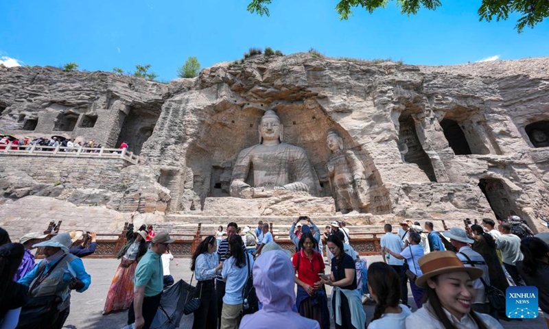 Tourists visit the Yungang Grottoes in Datong, north China's Shanxi Province, June 11, 2026.

Datong, home to the Yungang Grottoes and dubbed a living history of Chinese architecture, has in recent years pivoted to leveraging its rich cultural heritage with content innovations and digital technologies. (Xinhua/Yang Chenguang)