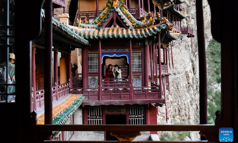 Tourists visit the Xuankong Temple in Hunyuan County, north China's Shanxi Province, June 9, 2026.

Datong, home to the Yungang Grottoes and dubbed a living history of Chinese architecture, has in recent years pivoted to leveraging its rich cultural heritage with content innovations and digital technologies. (Xinhua/Cao Yang)

