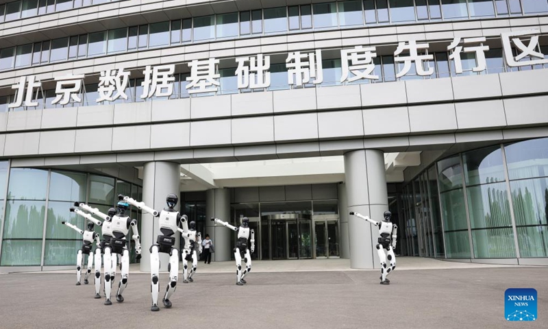 Humanoid robots welcome visitors with a dance outside the embodied intelligence robot data and training base of the Beijing Innovation Center of Humanoid Robotics in Beijing, capital of China, June 12, 2026.

