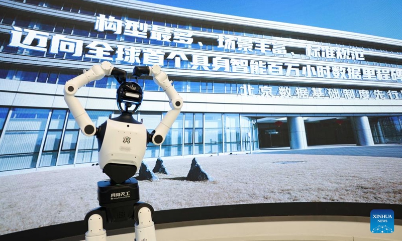 A humanoid robot gestures at the embodied intelligence robot data and training base of the Beijing Innovation Center of Humanoid Robotics in Beijing, capital of China, June 12, 2026.

