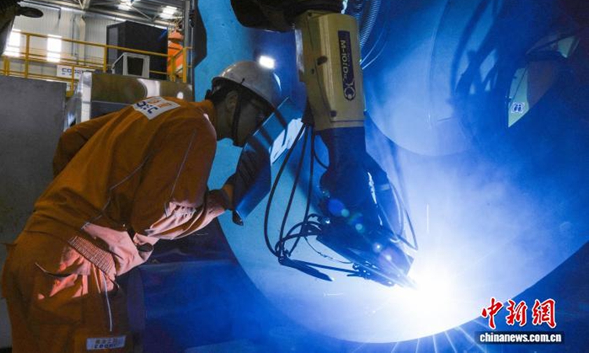 China puts into operation its first domestically developed intelligent welding robot system for flexible manufacturing in marine engineering in Tianjin on June 14, 2026. The photo shows an engineer conducting on-site spot checks on the welding robot's operational performance. Photo: Screenshot from chinanews.com.cn