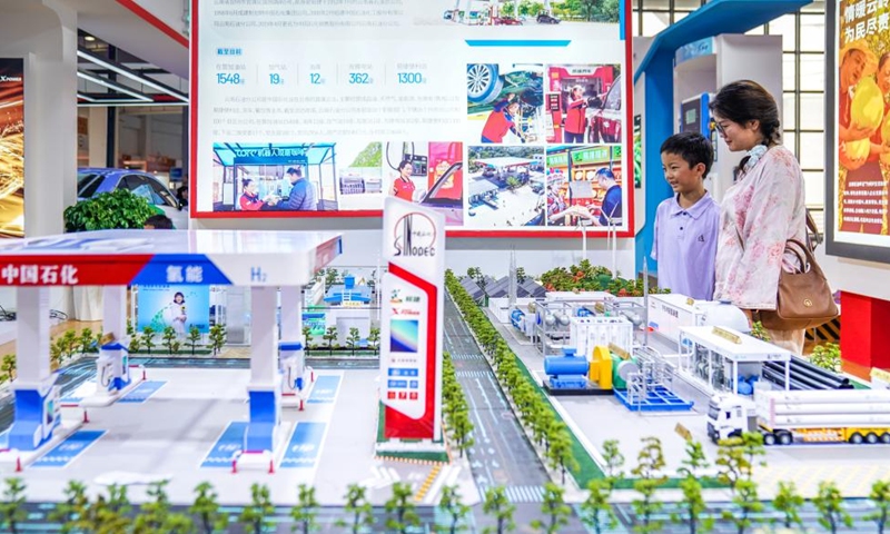 Visitors look at a sand table showcasing the hydrogen energy business model at the Green Energy Pavilion during the 10th China-South Asia Expo in Kunming, southwest China's Yunnan Province, June 13, 2026. (Xinhua/Peng Yikai)