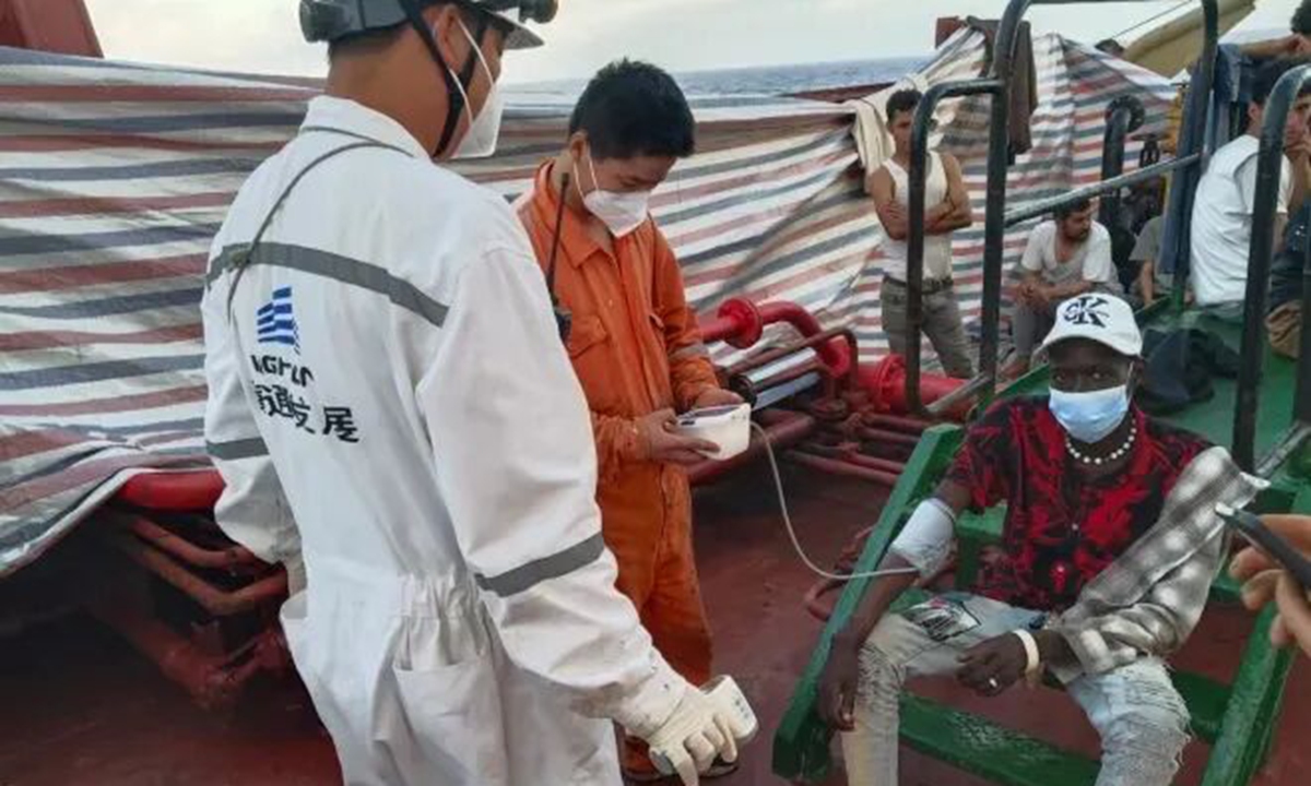 Crew members of the Xin Hai Tong 801 provide humanitarian care, including medical assistance, food and clothing, after the rescued people boarded the vessel. Photo: Official WeChat account of China's Ministry of Transport