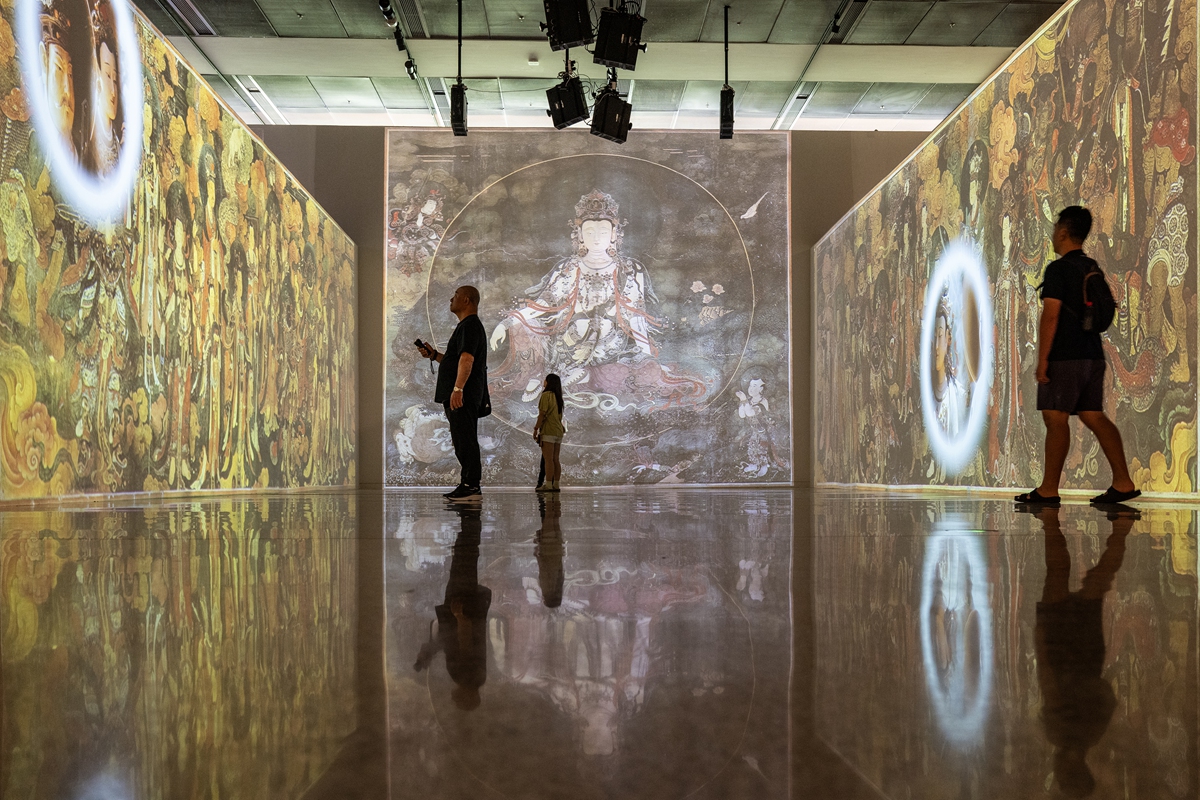 Visitors appreciate displays about Ming Dynasty (1368-1644) temple murals and painted sculptures during an exhibition at the Chinese Traditional Culture Museum in Beijing on June 14, 2026. The exhibition is centered on the murals and painted sculptures from the imperial Buddhist and Taoist temples of the Ming and Qing (1644-1911) dynasties in Beijing. Photo: VCG