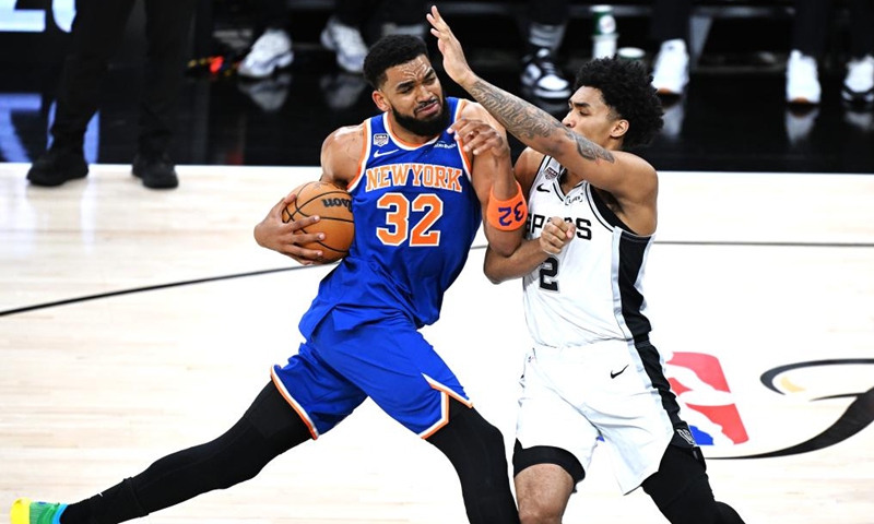 Karl-Anthony Towns (L) of New York Knicks vies with Dylan Harper of San Antonio Spurs during the final game 5 between New York Knicks and San Antonio Spurs at the 2025-2026 NBA basketball game in San Antonio, the United States, June 13, 2026. (Xinhua/Wu Xiaoling)
