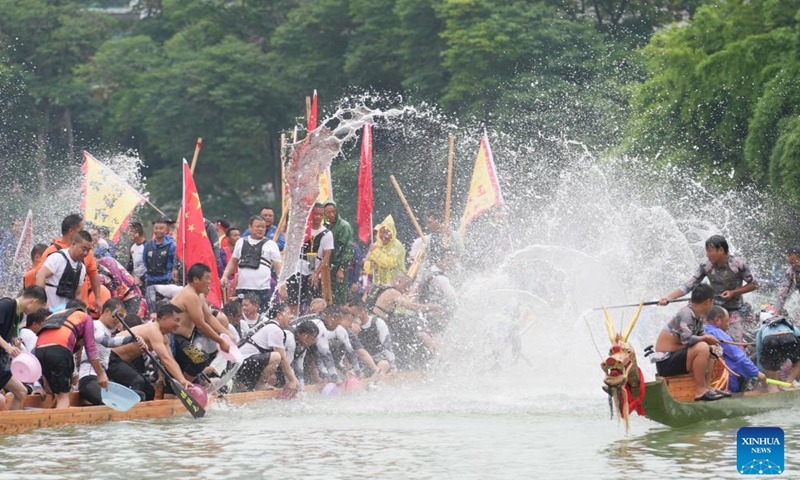 Dragon boat teams take part in a waterborne parade at Bijiang District of Tongren, southwest China's Guizhou Province, on June 14, 2026. Various dragon boat-themed activities have been held across China to welcome the upcoming Dragon Boat Festival, which falls on June 19 this year. (Photo by Shen Yikai/Xinhua)