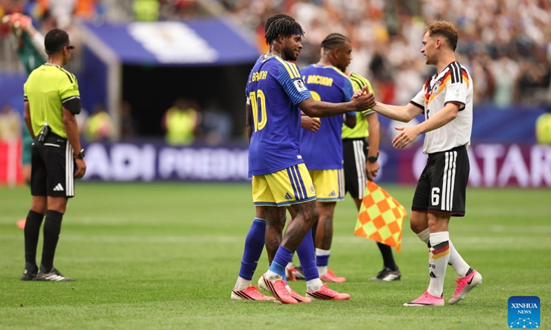 Leandro Bacuna (2nd L) of Curacao and Joshua Kimmich (1st R) of Germany shake hands during the group E match between Germany and Curacao at the 2026 FIFA World Cup at Houston Stadium in Houston, the United States, June 14, 2026. (Xinhua/Li Ming)