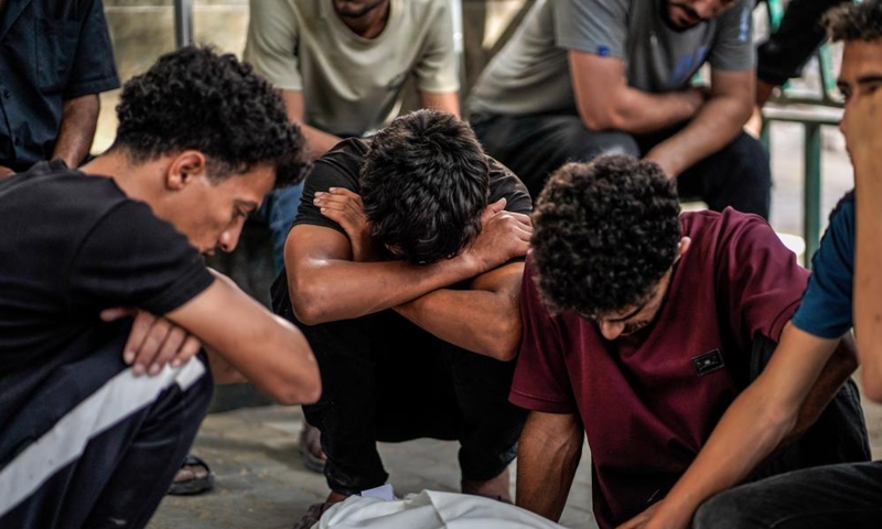 Palestinians mourn over victims killed in an Israeli airstrike, at Al-Shifa hospital in Gaza City, on June 14, 2026. (Photo by Rizek Abdeljawad/Xinhua)