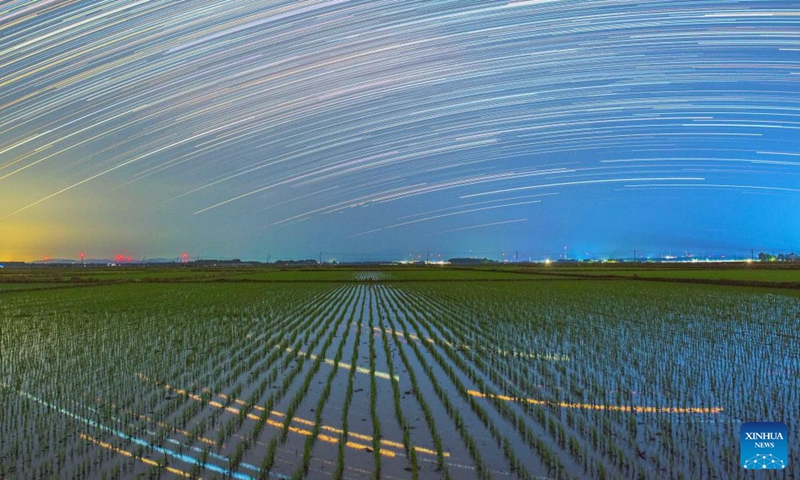 This stack composite photo taken on May 22, 2026 shows paddy fields under starry sky in Huachuan County, northeast China's Heilongjiang Province. (Photo by Chen Zhiguo/Xinhua)