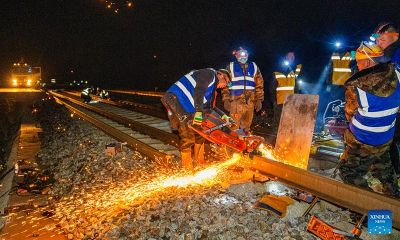 Workers remove old rails on the Golmud-Lhasa section of the Qinghai-Xizang Railway at Amdo South Station in Amdo County of Nagqu, southwest China's Xizang Autonomous Region, June 13, 2026. Braving an altitude of over 4,000 meters, workers from the railway maintenance company of China Railway 12th Bureau Group Co., Ltd. have recently replaced the old rails with the seamless tracks on the Golmud-Lhasa section of the Qinghai-Xizang Railway. All jobs were done during night-time idle period without train traffic at Amdo South Station in Amdo County of Xizang. (Xinhua/Tenzin Nyida)