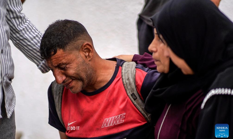 Palestinians mourn over victims killed in an Israeli airstrike, at Al-Shifa hospital in Gaza City, on June 14, 2026. (Photo by Rizek Abdeljawad/Xinhua)