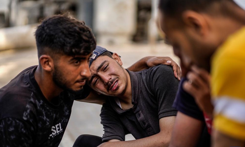 Palestinians mourn over victims killed in an Israeli airstrike, at Al-Shifa hospital in Gaza City, on June 14, 2026. (Photo by Rizek Abdeljawad/Xinhua)