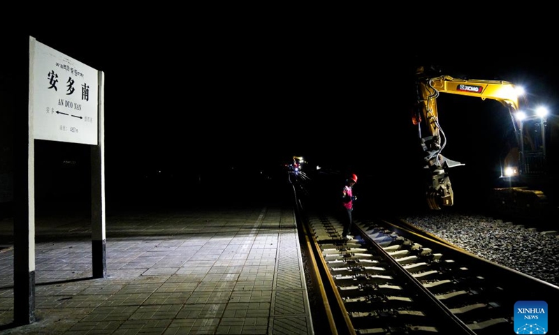 A worker checks the rails at the site of a rail replacement project on the Golmud-Lhasa section of the Qinghai-Xizang Railway at Amdo South Station in Amdo County of Nagqu, southwest China's Xizang Autonomous Region, June 12, 2026. Braving an altitude of over 4,000 meters, workers from the railway maintenance company of China Railway 12th Bureau Group Co., Ltd. have recently replaced the old rails with the seamless tracks on the Golmud-Lhasa section of the Qinghai-Xizang Railway. All jobs were done during night-time idle period without train traffic at Amdo South Station in Amdo County of Xizang. (Xinhua/Tenzin Nyida)