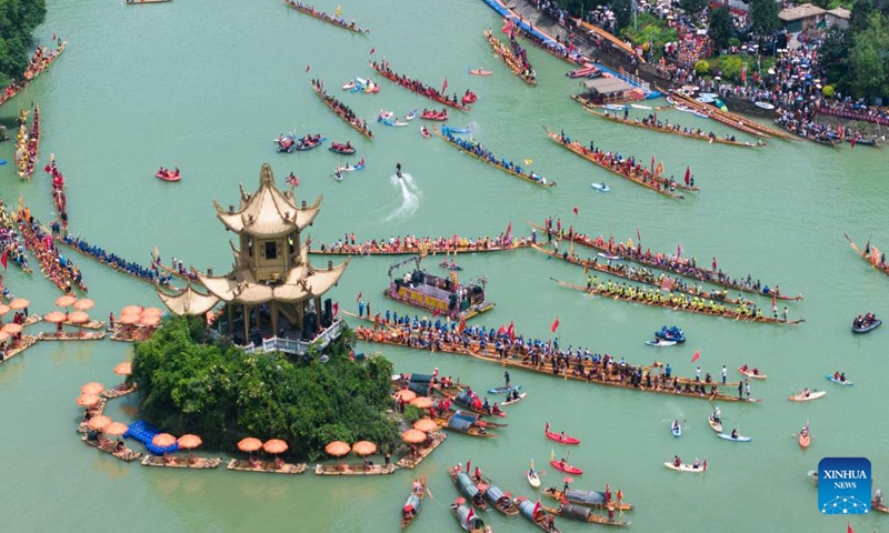 A drone photo taken on June 14, 2026 shows dragon boat teams taking part in a waterborne parade at Bijiang District of Tongren, southwest China's Guizhou Province. Various dragon boat-themed activities have been held across China to welcome the upcoming Dragon Boat Festival, which falls on June 19 this year. (Photo by Peng Jun/Xinhua)