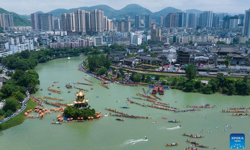 A drone photo taken on June 14, 2026 shows dragon boat teams taking part in a waterborne parade at Bijiang District of Tongren, southwest China's Guizhou Province. Various dragon boat-themed activities have been held across China to welcome the upcoming Dragon Boat Festival, which falls on June 19 this year. (Photo by Peng Jun/Xinhua)
