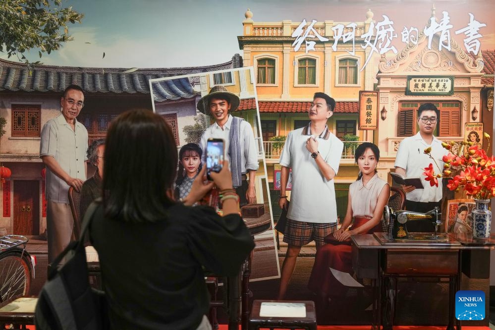 A woman takes photos during the special screening of Chinese film Dear You in Kuala Lumpur, Malaysia, June 15, 2026. The film will be released in major cinemas across Malaysia starting June 18. (Photo: Xinhua)