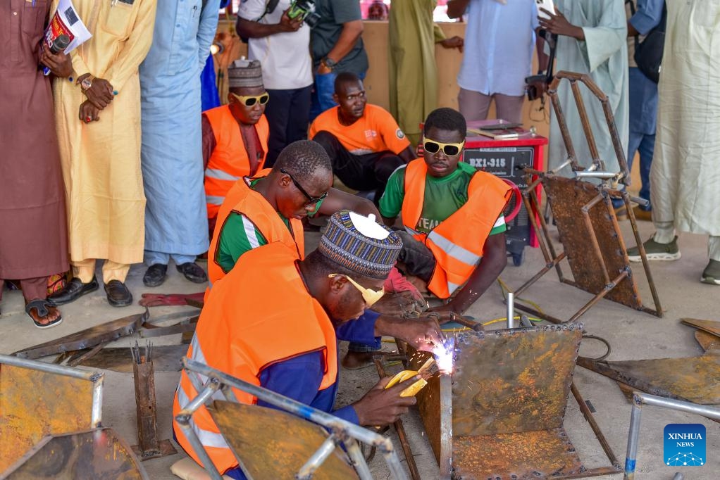 Workers demonstrate tricycle manufacturing at a vocational training center and tricycle workshop in Maiduguri, Nigeria, June 15, 2026. (Photo: Xinhua)